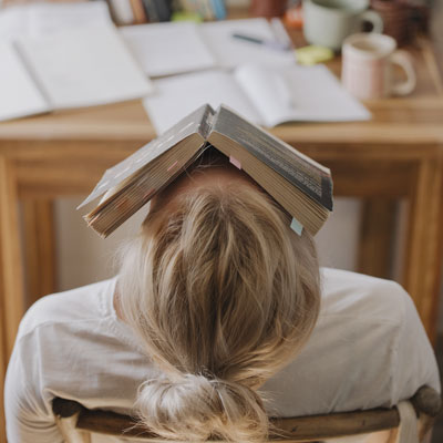 A person sleeping with a book over their face